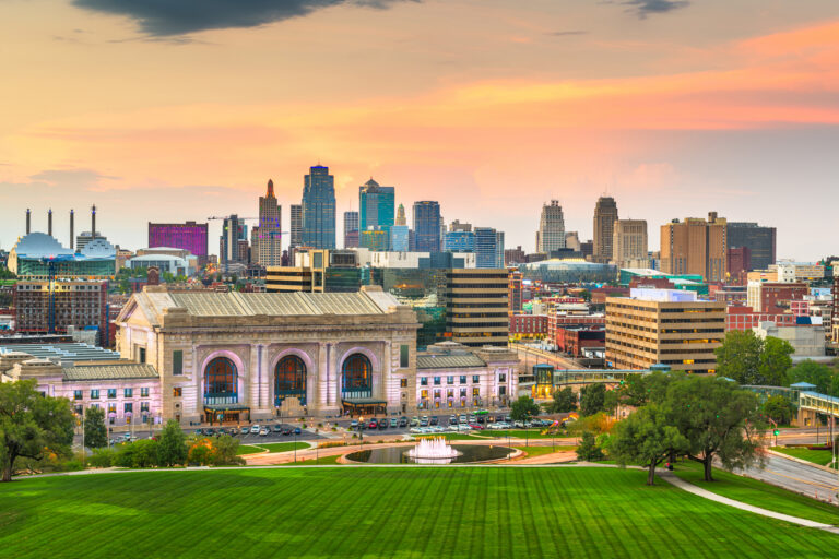 Kansas City, Missouri, USA downtown skyline with Union Station at dusk.